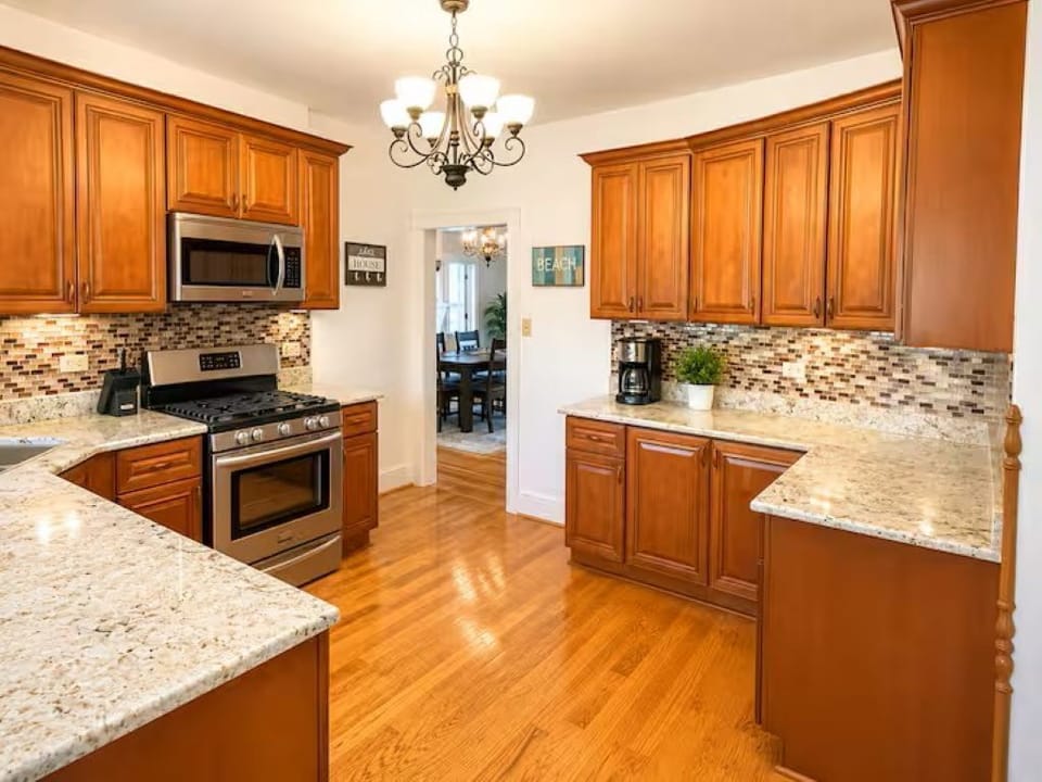 Spacious, fully stocked kitchen with stainless steel appliances, granite counter