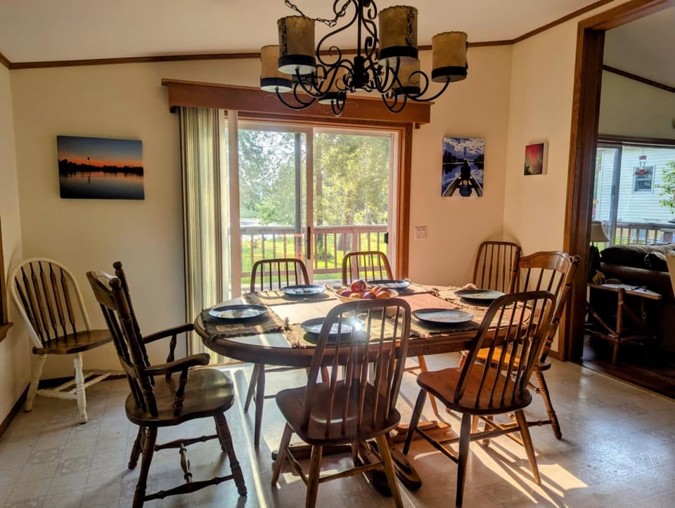 Dining area with sliding doors to lakeside deck.
