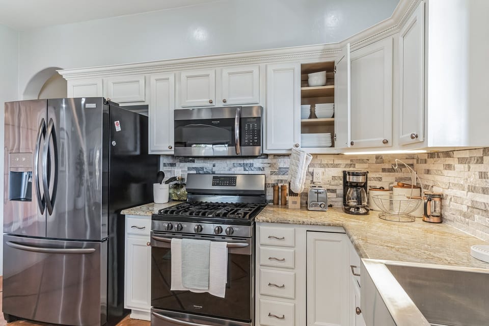 Stainless appliances and built-in pantry wall.