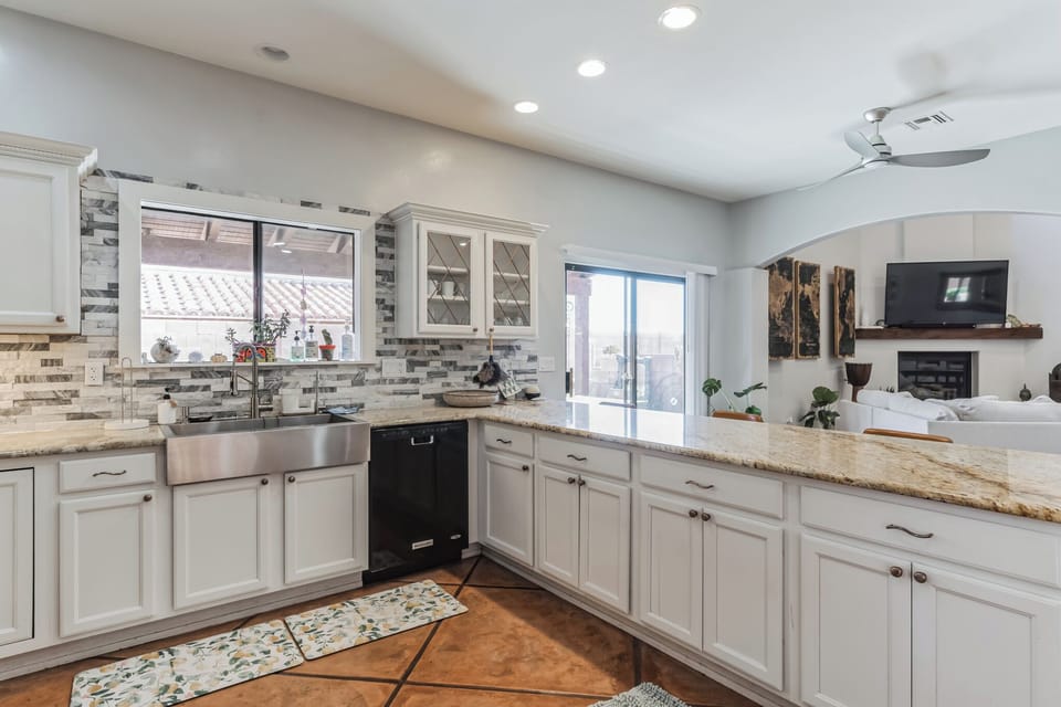 Open and airy kitchen with garden views and open layout to living area. 