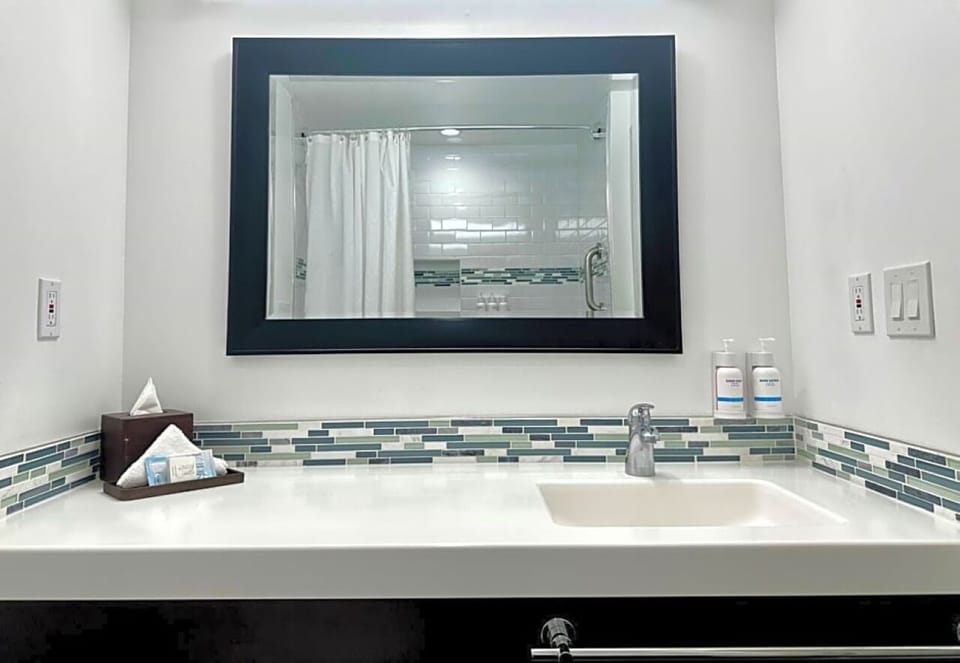 Refresh at a spotless vanity with bright lighting and amenities.