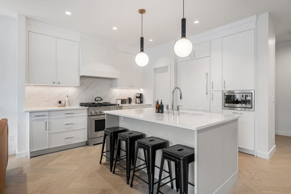 Full kitchen with a large island, coffee makers (drip & french press), and an air fryer.
