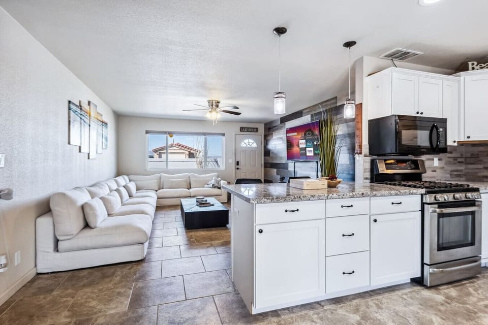 A spacious open-concept living area with plush seating and a modern, fully equipped kitchen with an island perfect for gathering.