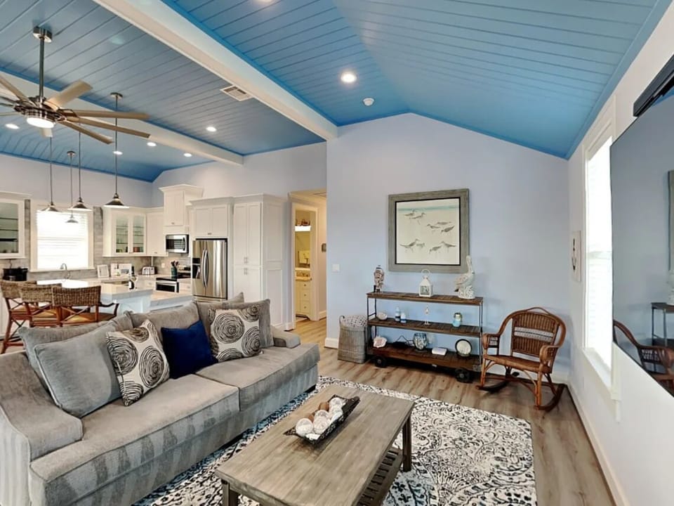 Open-plan living room with a roomy sofa, oversized Smart TV for movie nights!