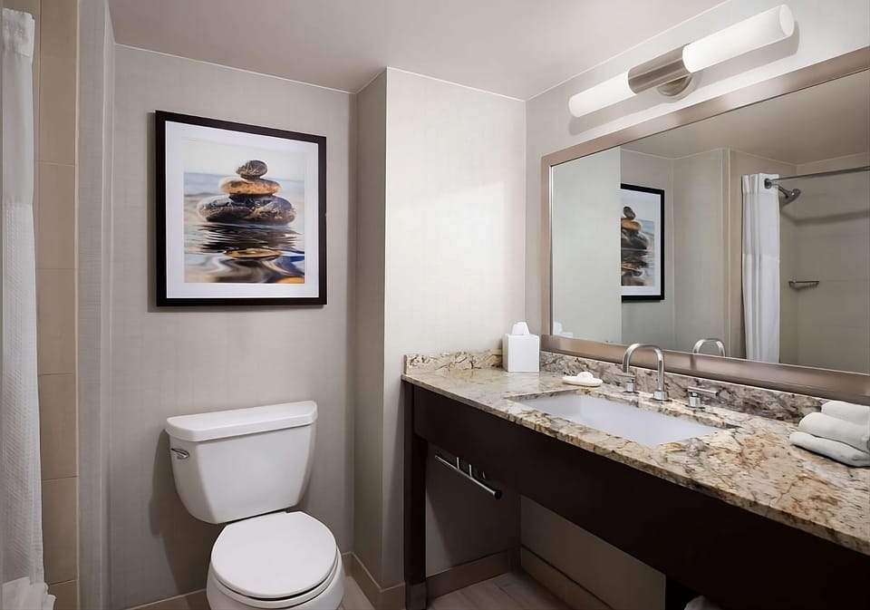 Refresh effortlessly with granite counters and bright vanity lighting.