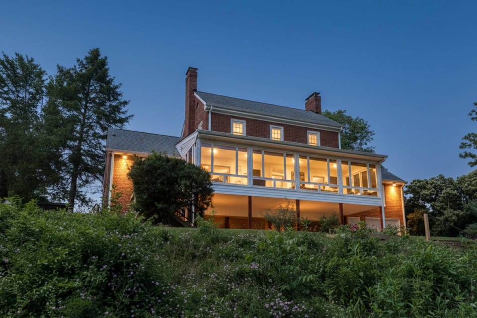 View of the back exterior and steps leading down to the lake