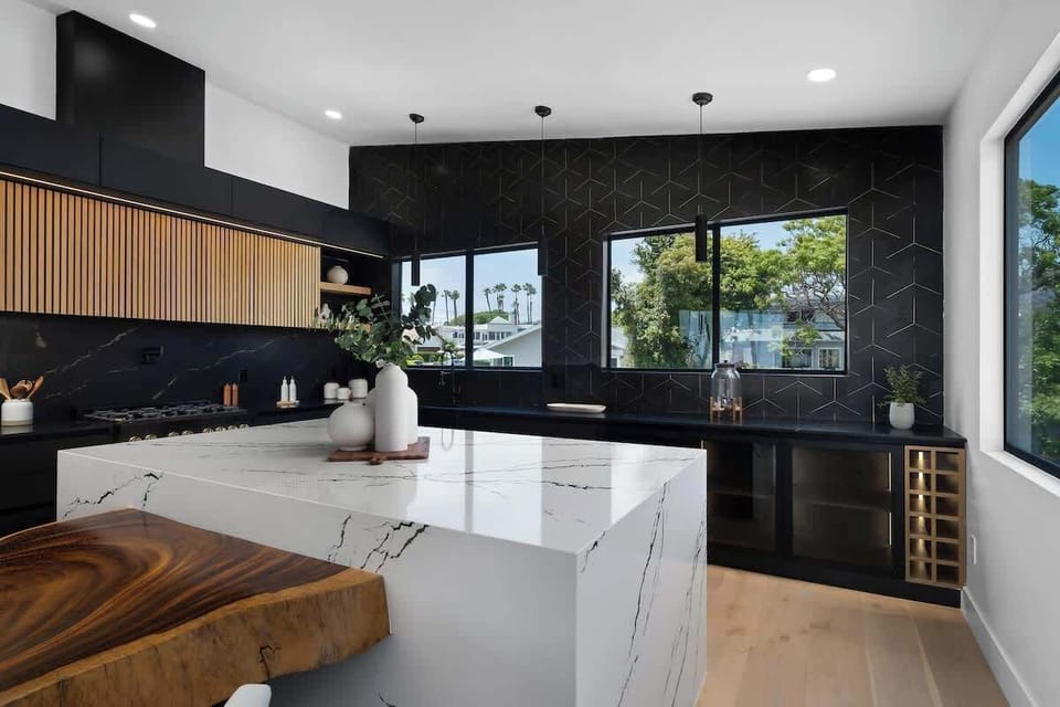 A sleek black kitchen, natural wood accents, and a waterfall island—this space is designed to impress. Add in that San Diego view, and it's pure perfection.