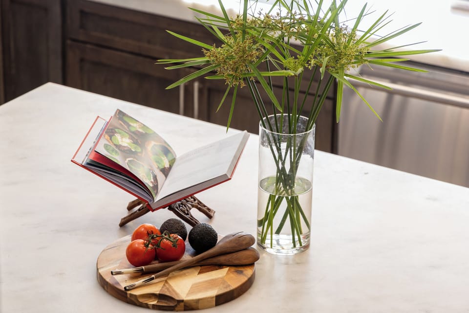 Charming kitchen details with a stylish plant and cookbook adding a warm, homey touch to the countertop.