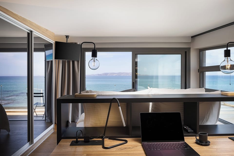 It also includes a work desk with a chair, a 32” LG TV, a floor-to-ceiling closet, and a private balcony