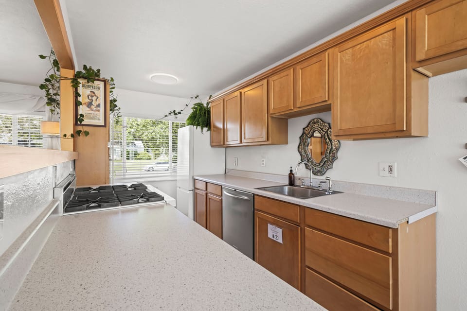 Fresh mornings start here—light, space, and charm fill this well appointed kitchen.