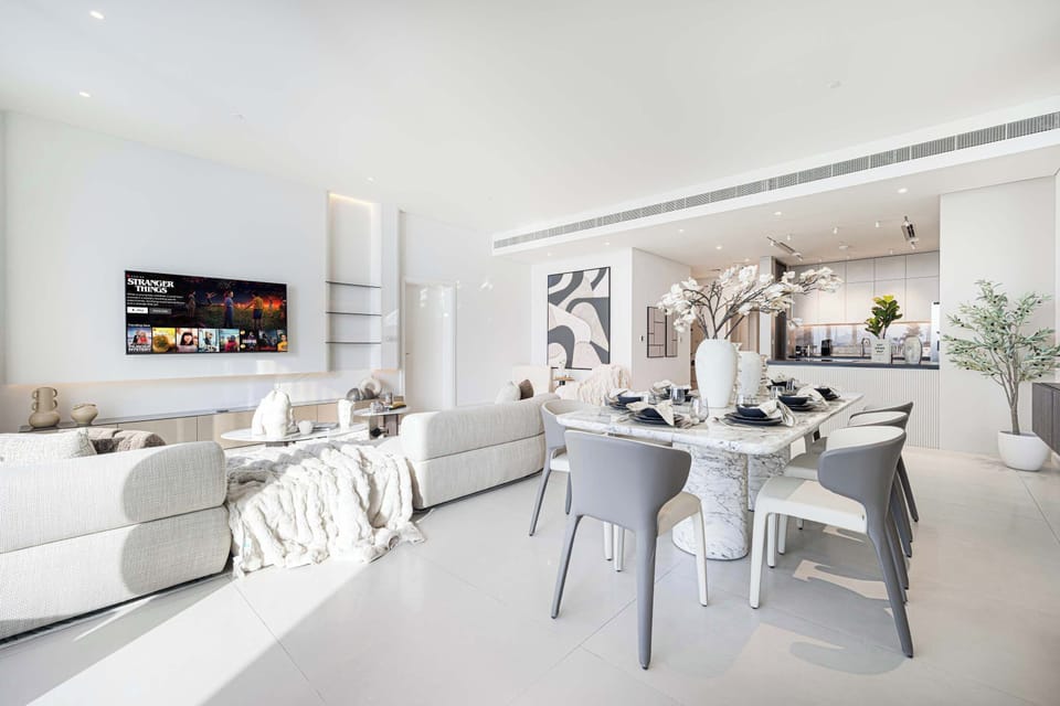 Stunning open plan lounge and dining area with 65 inch Smart TV,  floor to ceiling windows, balcony and incredible sea view