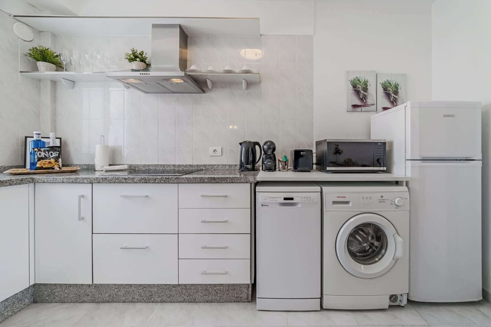 Fully Equipped Kitchen with Fridge, Dishwasher, Washing Machine, Coffee Maker & More. 