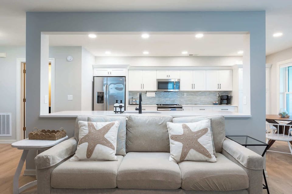 Bright, open living room with a large TV and comfy seating