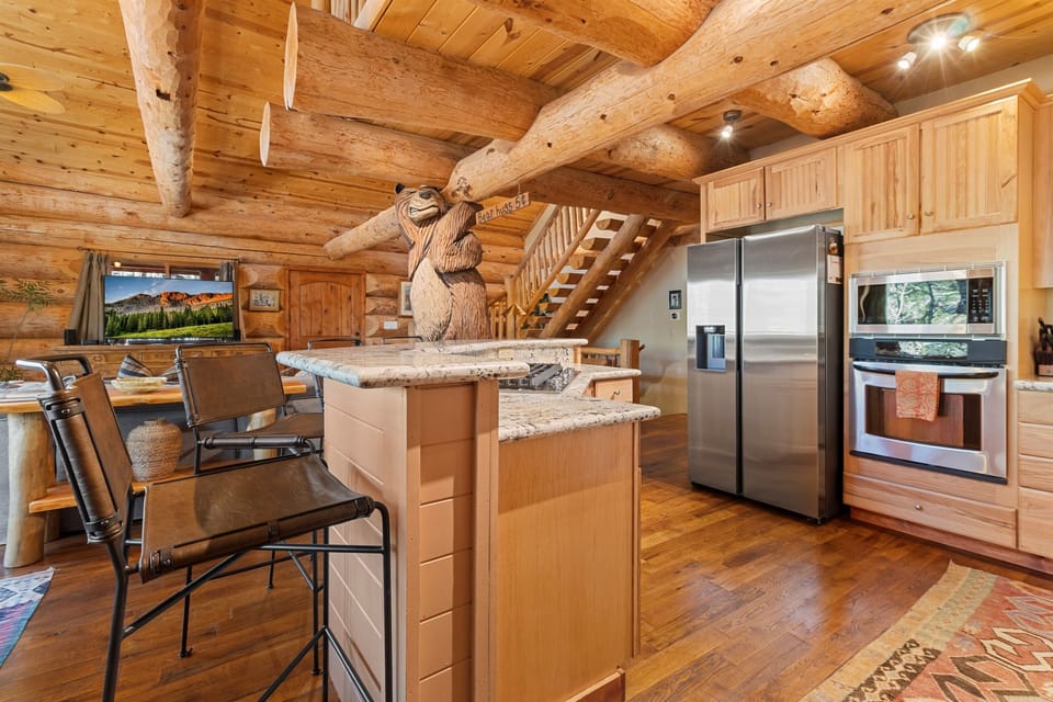 Show stopping kitchen with custom bear carving and spacious island seating