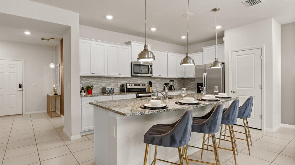 Fully equipped gourmet kitchen with silver appliances 