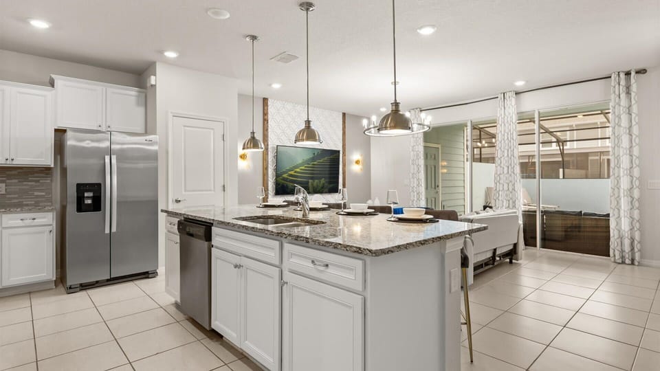 Fully equipped gourmet kitchen with silver appliances 
