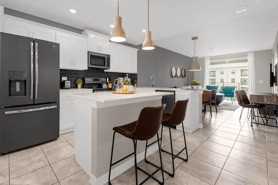 Fully Equipped Chef’s Kitchen With Sleek Appliances And Island Seating