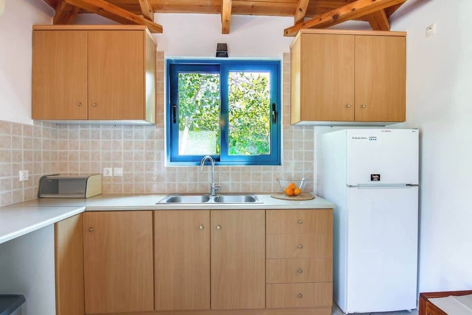 Fully equipped kitchen area with dining space and a rustic touch.