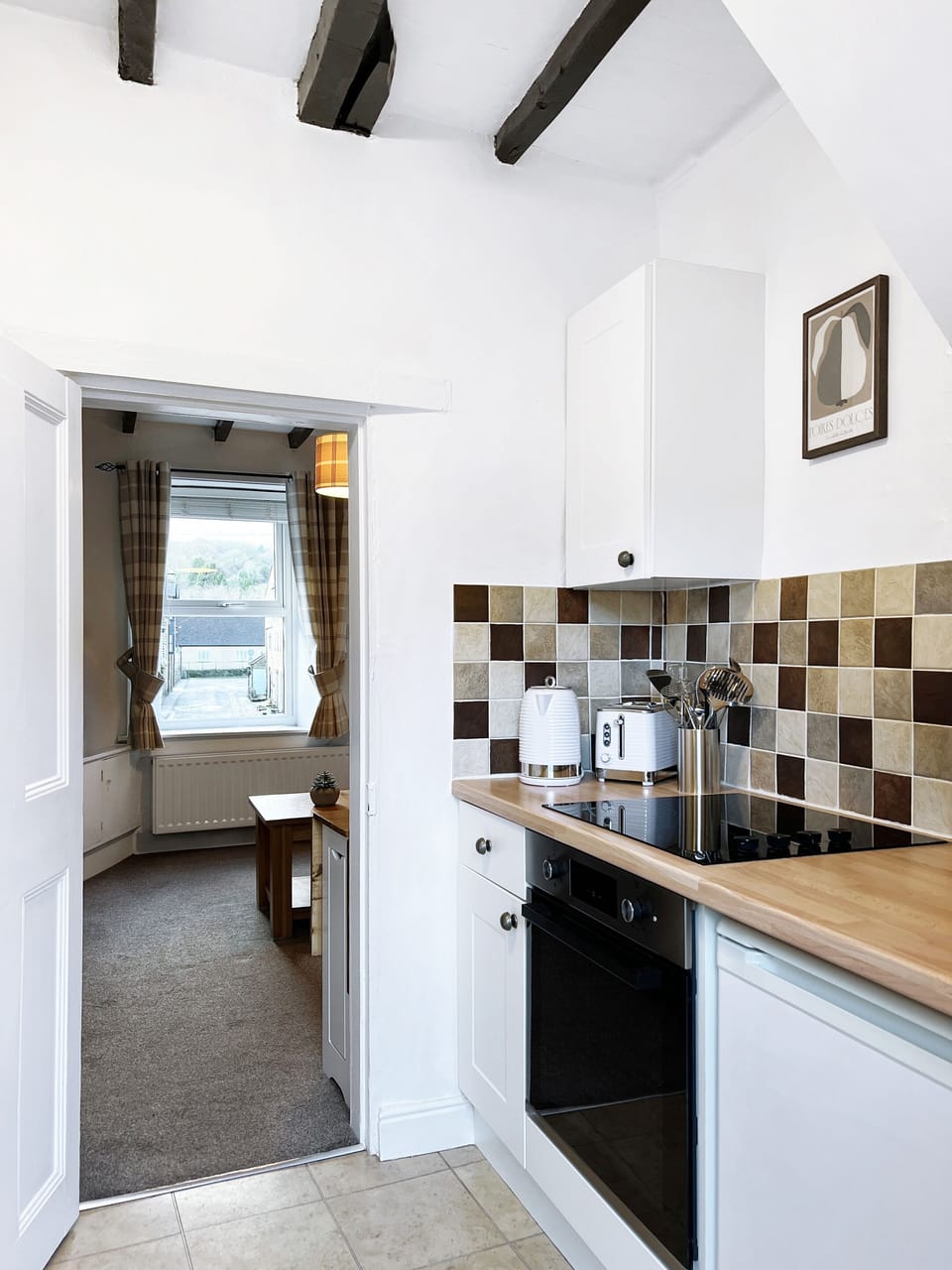 Galley kitchen through to the dining area