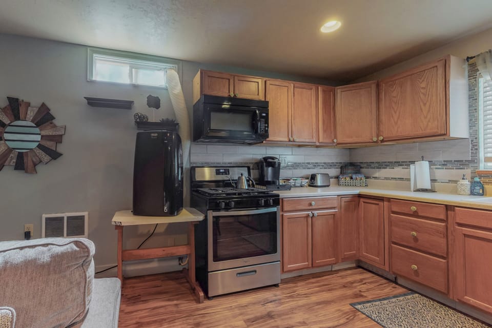 Full kitchen with stove, refrigerator, microwave, and Keurig