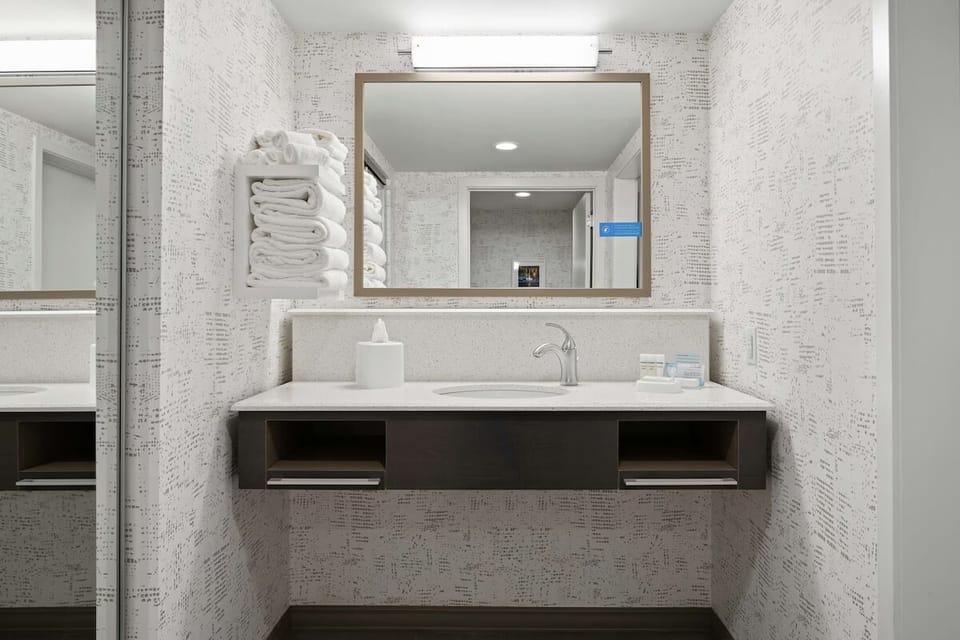 Refresh at a wide vanity with clean towels ready.