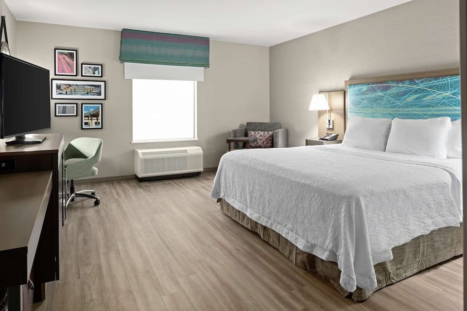 Relax in a spacious room with cozy chair and calm vibes.