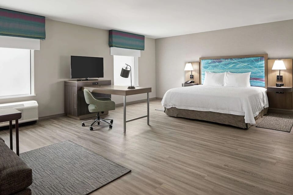 Unwind in a bright king room with dedicated workspace.