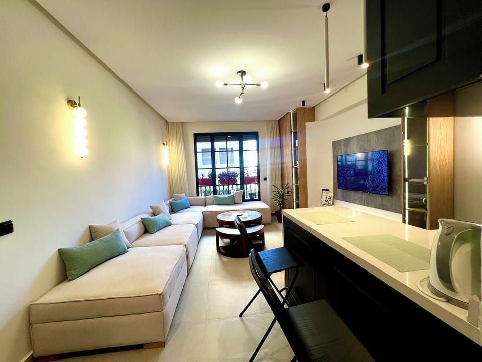 Living Room area with big TV screen and American kitchen