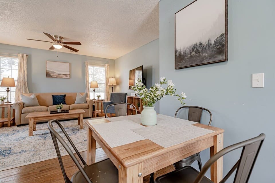 Fully-equipped kitchen with dining table opens to the living room.