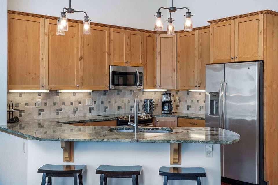 Main level kitchen with breakfast bar seating.