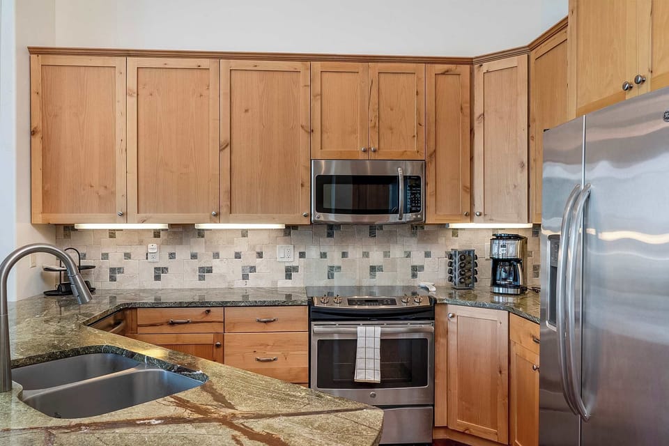 Main level full kitchen with breakfast bar seating.