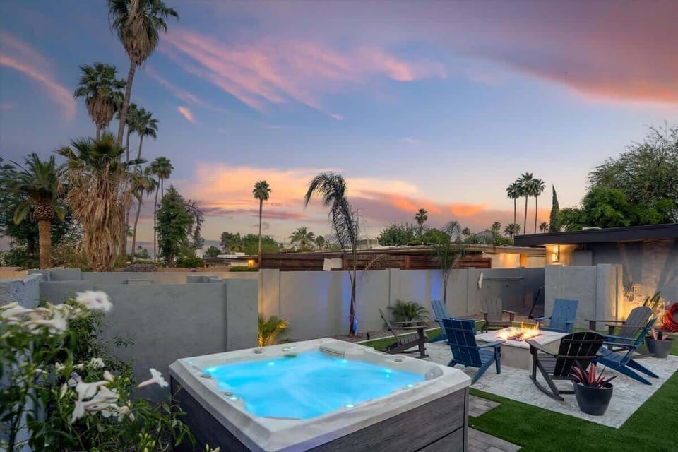 Unwind in the hot tub as the sun sets, surrounded by serene outdoor seating and beautiful views.