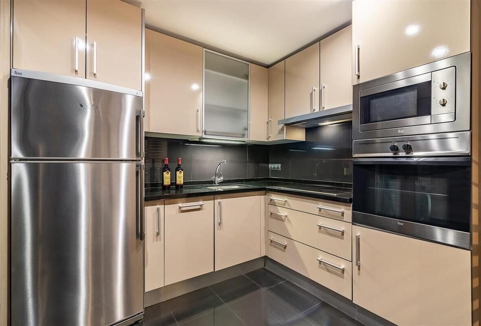 Modern kitchen in this apartment is fully fitted with all the appliances
