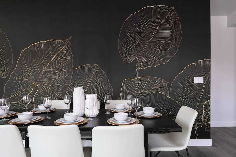 Dining area with artistic wall design and elegant setup
