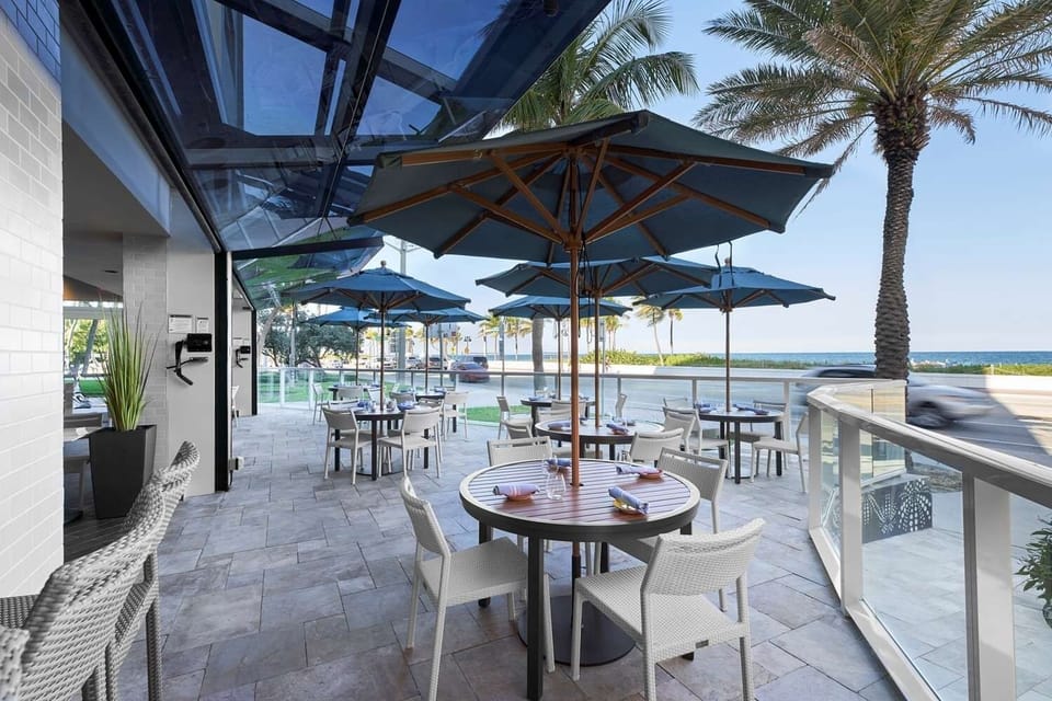 Linger over alfresco meals steps from the sparkling shoreline.