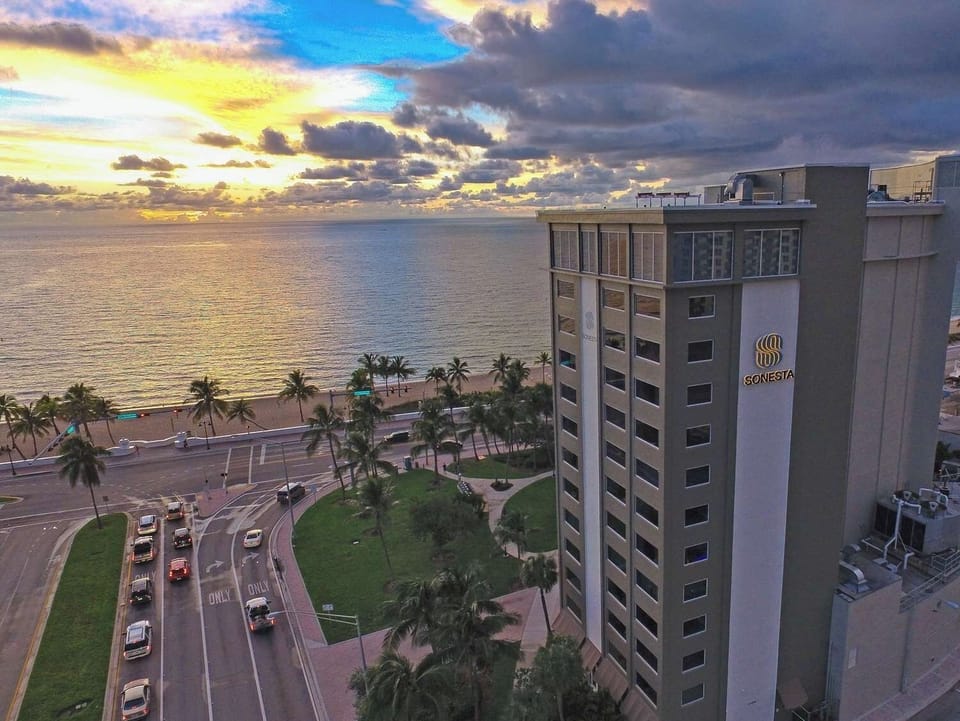 Unwind at sunset with sweeping oceanfront views and palms.