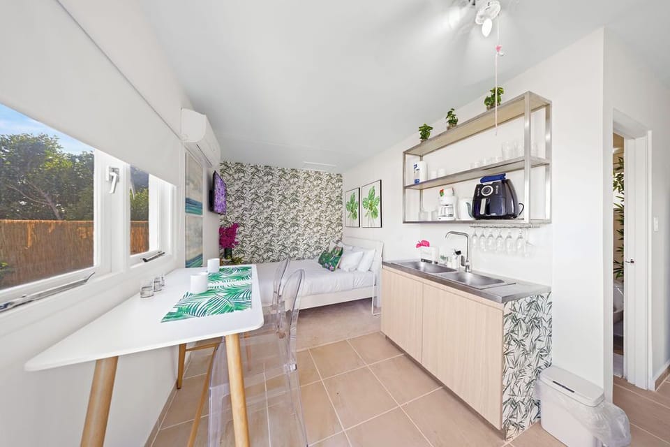 Prep light bites with ease using a well-equipped kitchenette featuring a mini-fridge, microwave, coffee maker, blender, and toaster.