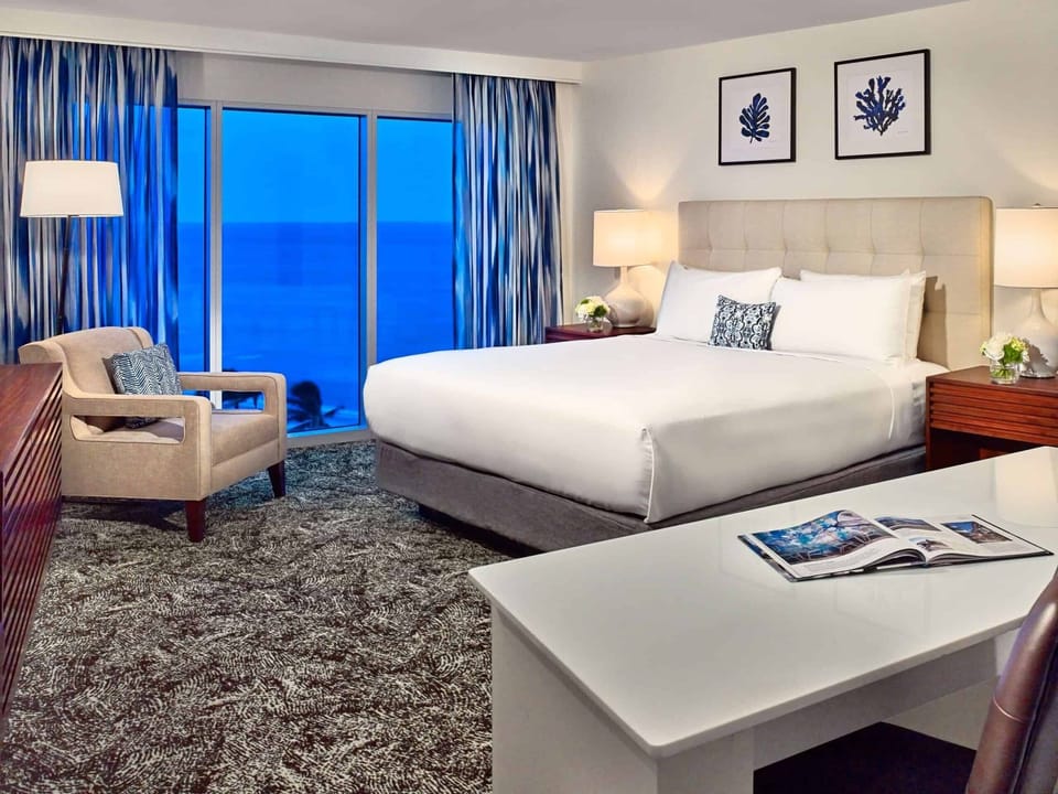 Relax at dusk as deep-blue ocean light fills the room.