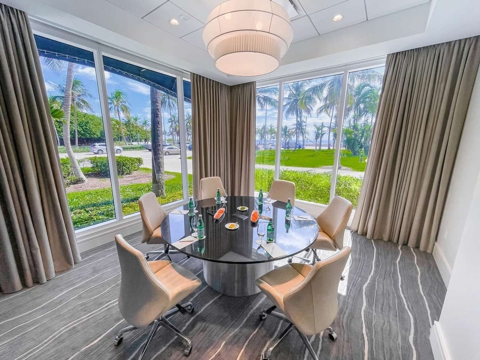 Gather with ease in a sunlit room framed by palms.