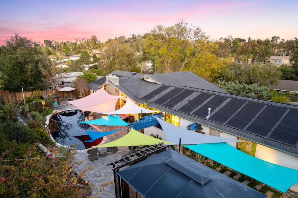 Colorful shade sails create a whimsical outdoor oasis.