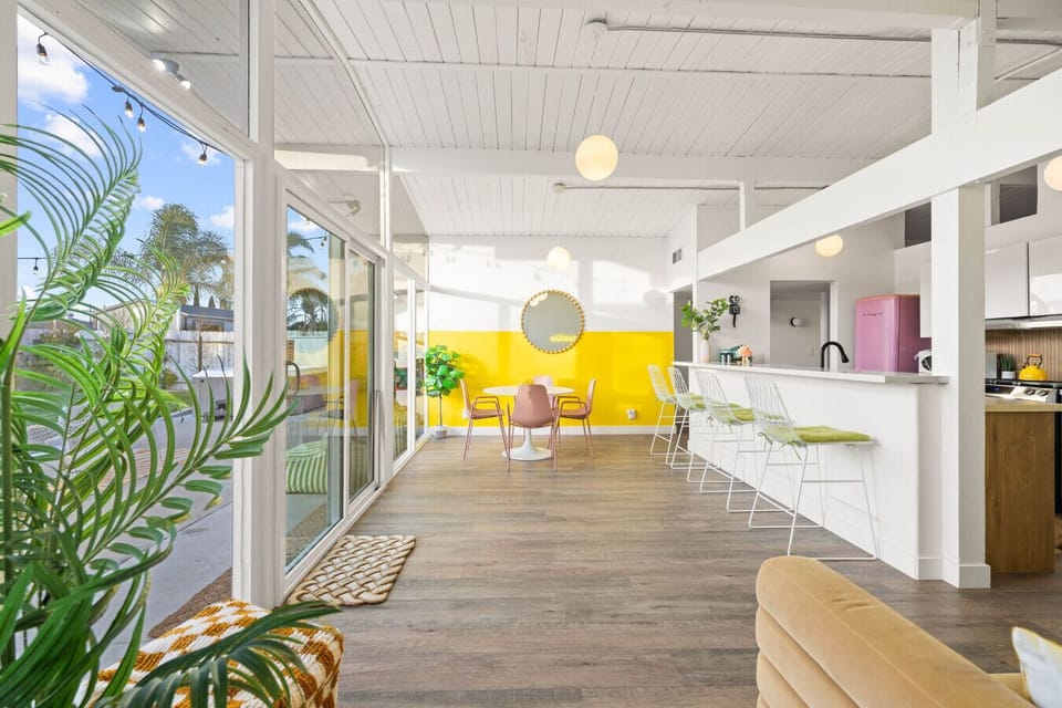 This sun-drenched dining area is bursting with color, charm, and backyard views.