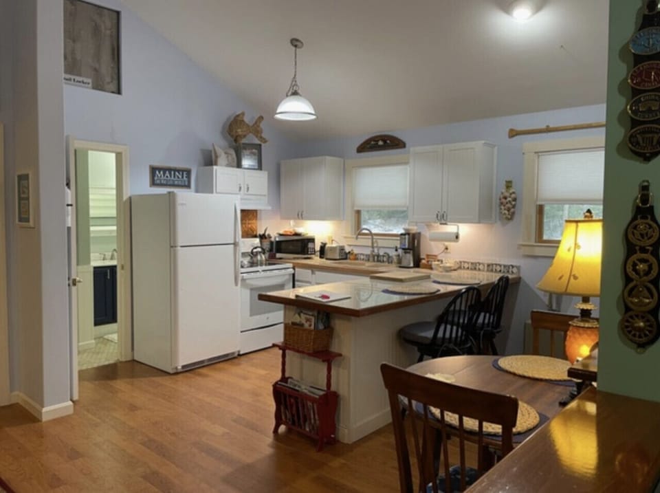 Fully equipped kitchen with island seating, cooking basics, coffee, and everything you need for home-style meals