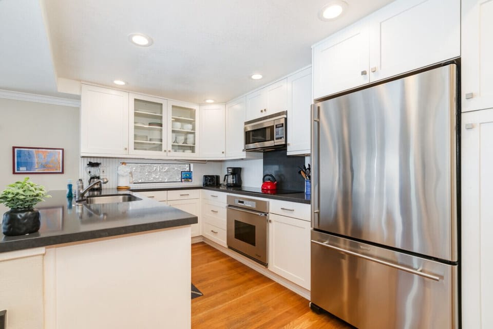 The sleek stainless steel appliances and crisp white cabinetry bring style and function to every meal.