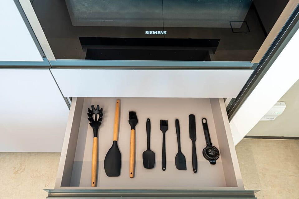 Modern kitchen equipped with essential cooking utensils for your culinary needs.
