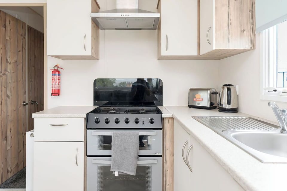 Modern kitchen with a gas stove, ample counter space, and essential appliances—ideal for home-cooked meals.