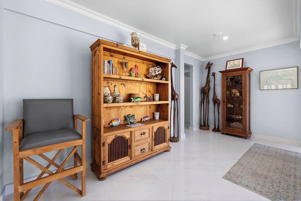 Spacious, sunlit living area with plush seating, 85” Smart TV, and easy backyard access—perfect for unwinding in style.