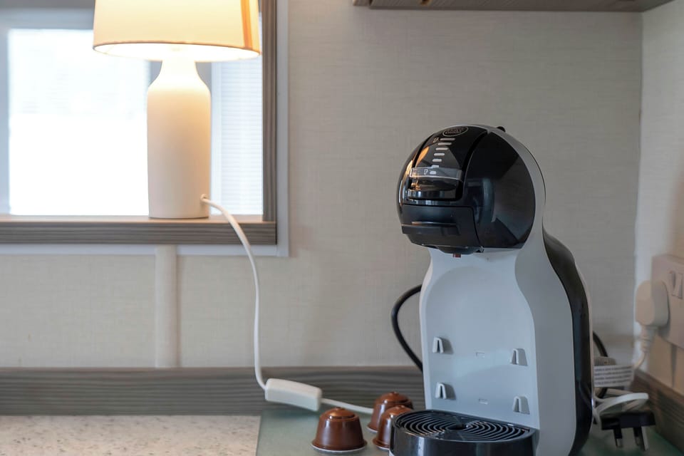 Coffee machine with complimentary pods for your morning brew.
