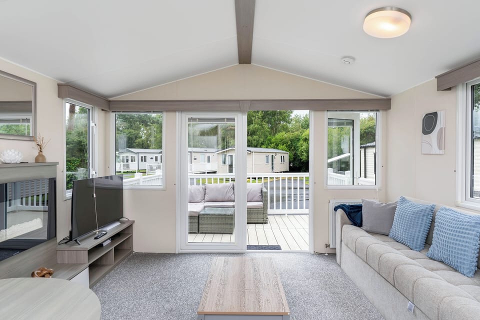 Spacious living room with large windows offering plenty of natural light and outdoor views.