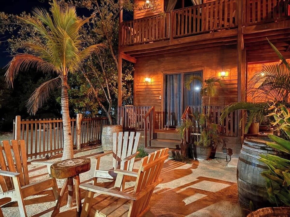 Shared rooftop lounge with rocking chairs and plants