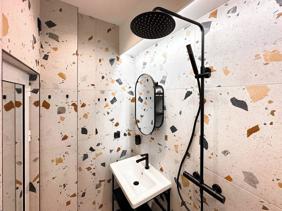 Enjoy a spa-like shower with rainfall head and designer tiles. Curious about included toiletries? We’re happy to tell you!